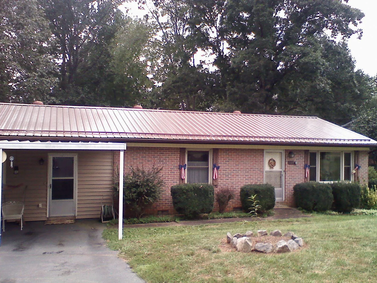 Bronze metal roof and carport on a brick ranch home — Roof Repair work by our crew in Pequea